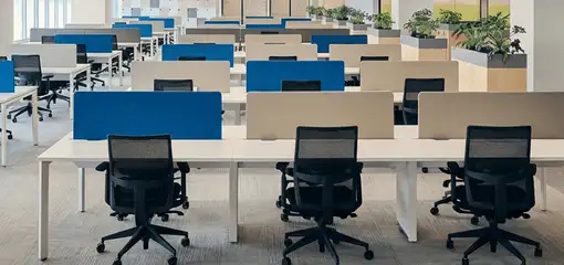 Modern open-plan office space featuring clean workstations, ergonomic chairs, and sanitized carpets provided by professional office cleaning services in Aurora, CO.
