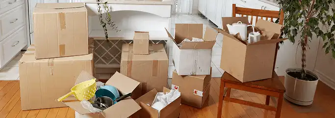Packed moving boxes and household items in a kitchen before move-out or move-in cleaning, Aurora, CO.